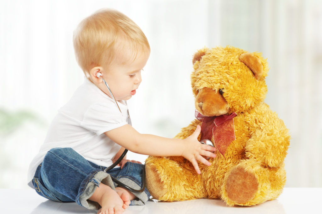 Child checking heart of teddy