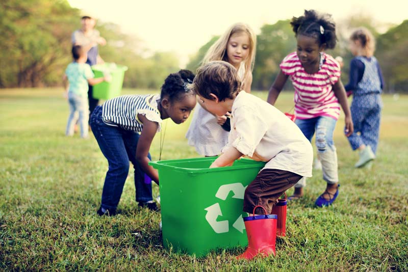 Young children recycling